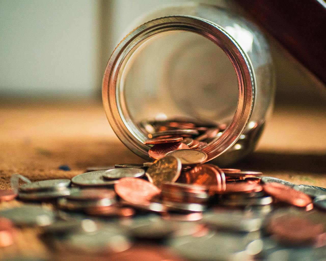 coins falling out of a jar