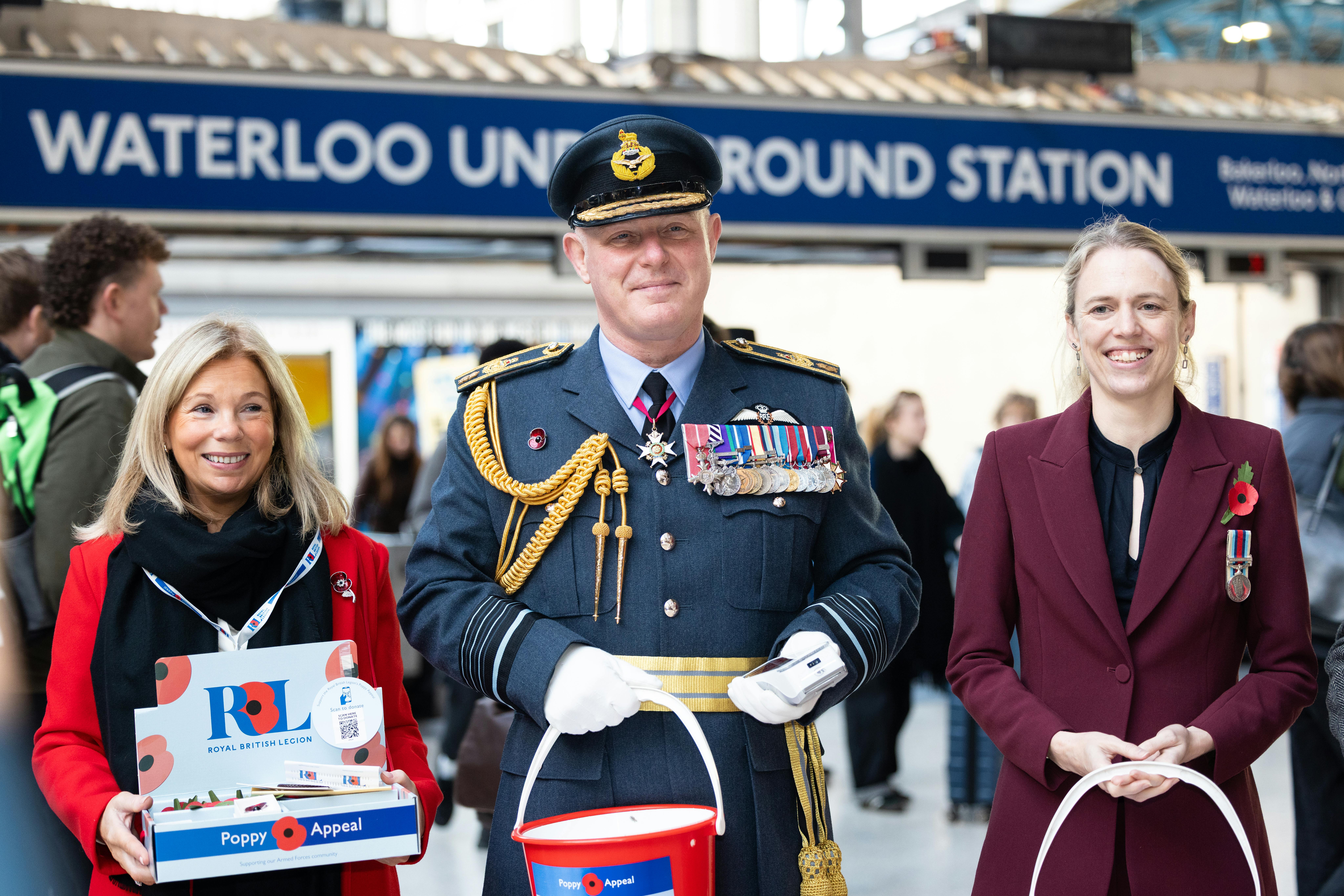 people outside Waterloo Underground Station with poppys