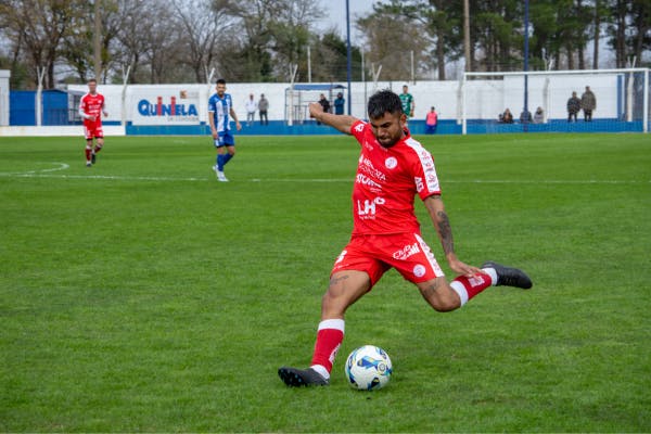 veteran kicking a football on pitch
