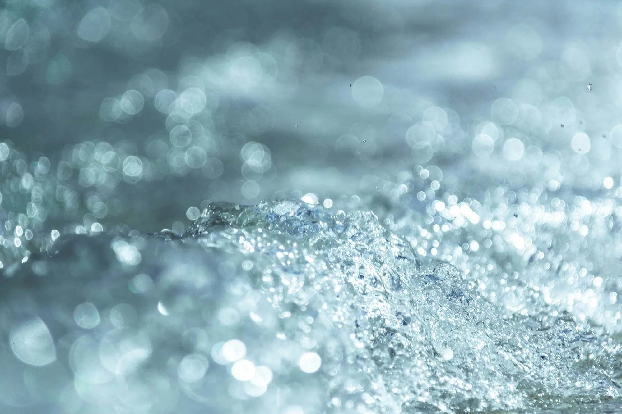 Extreme closeup of flowing, bubbly water
