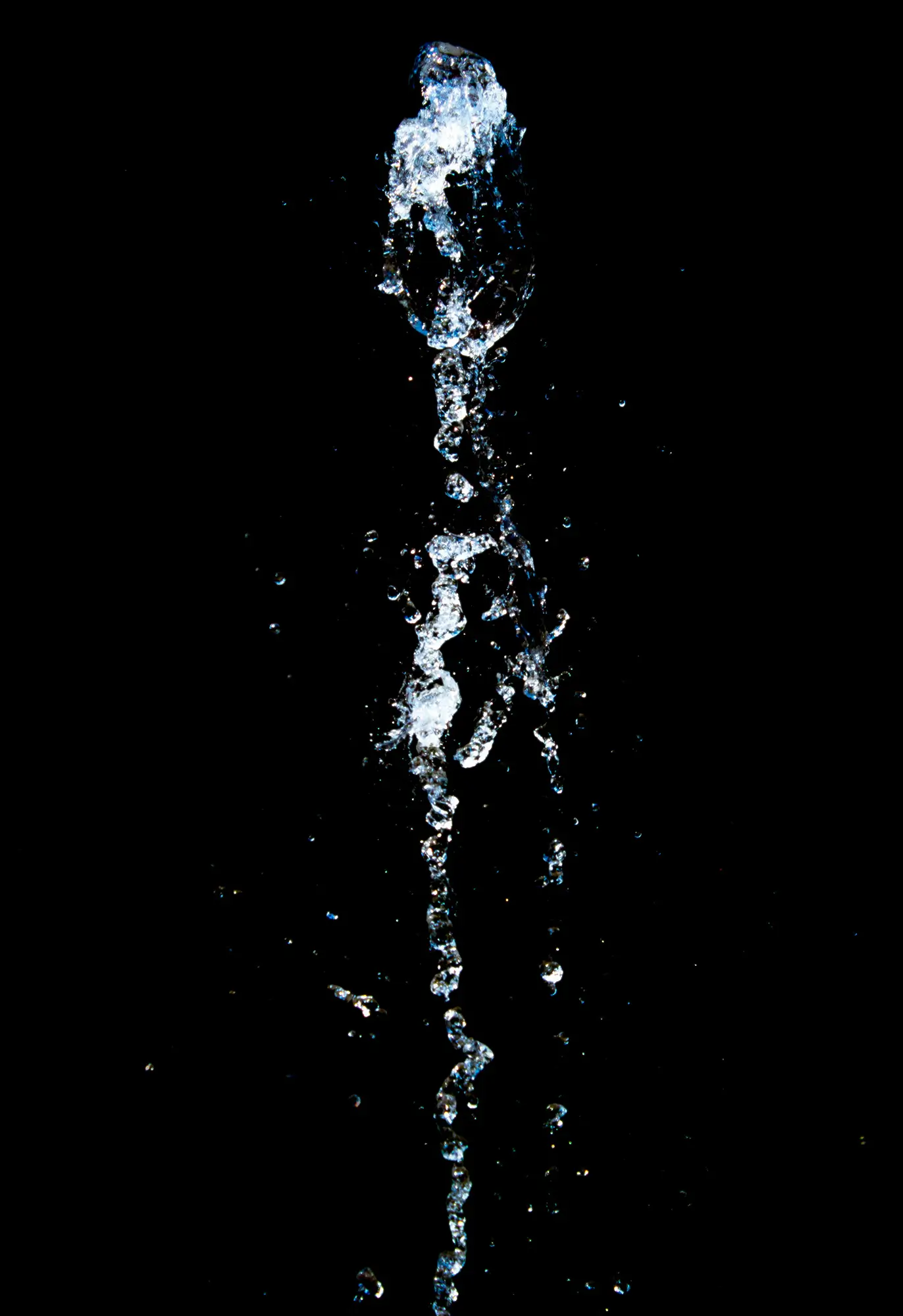 Extreme closeup of a bubbly stream of water against a black background