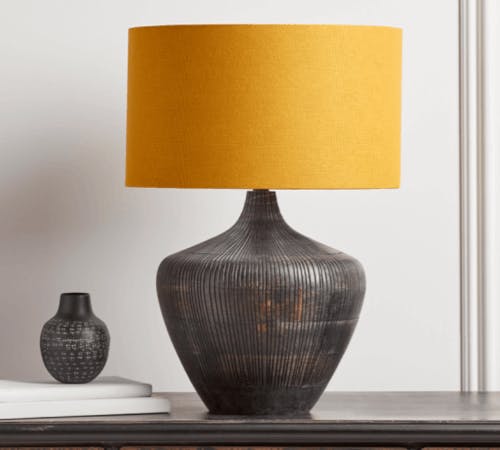 a mango wood lamp with yellow shade