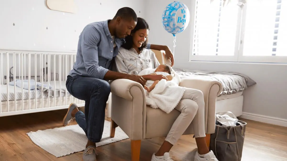 Couple in nursery holding baby