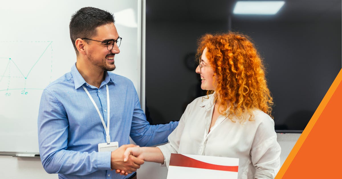 Man and woman shaking hands for certification