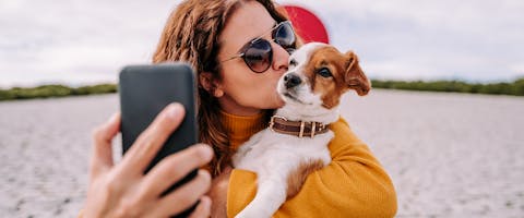 A woman taking a selfie with her dog