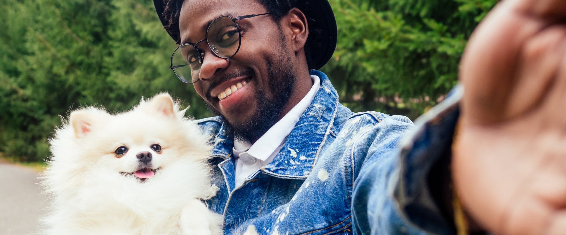 A man takes a selfie with his dog.