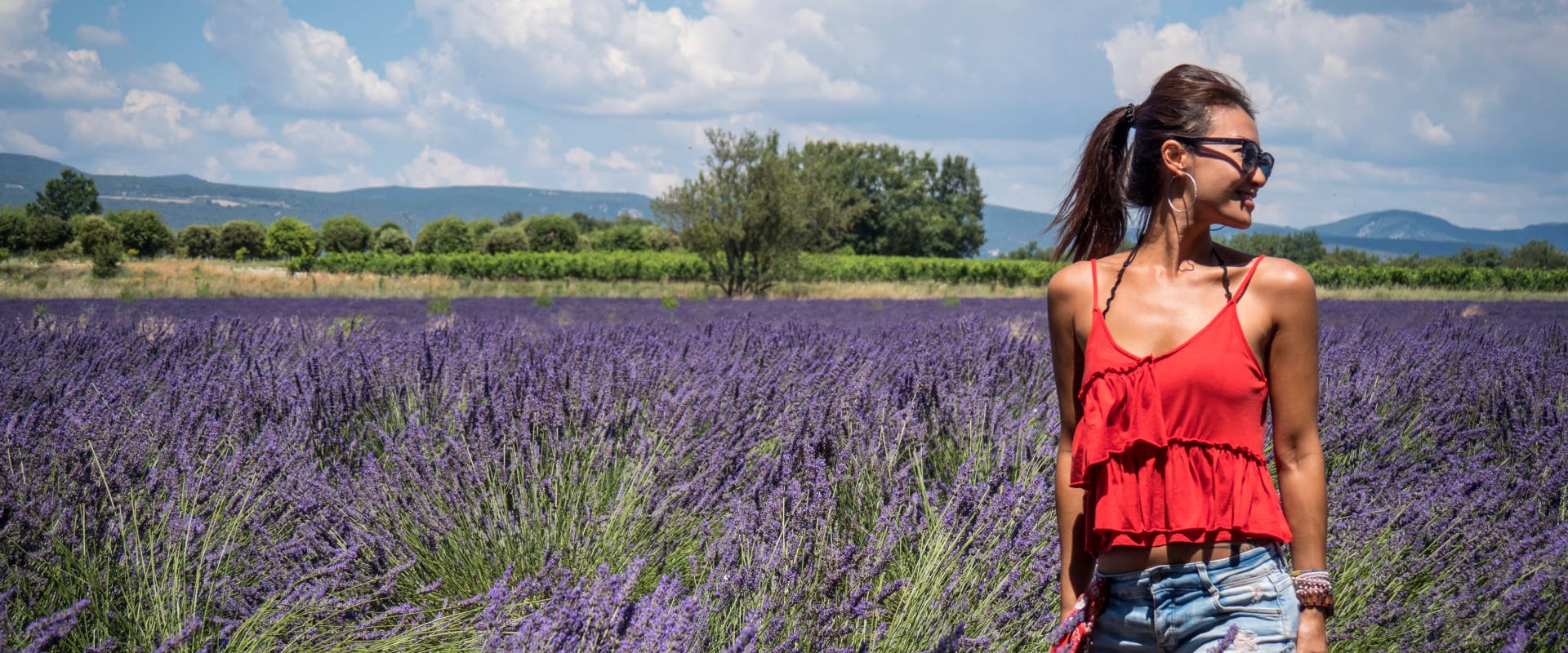 a solo female traveler in France standing next to a lavender field