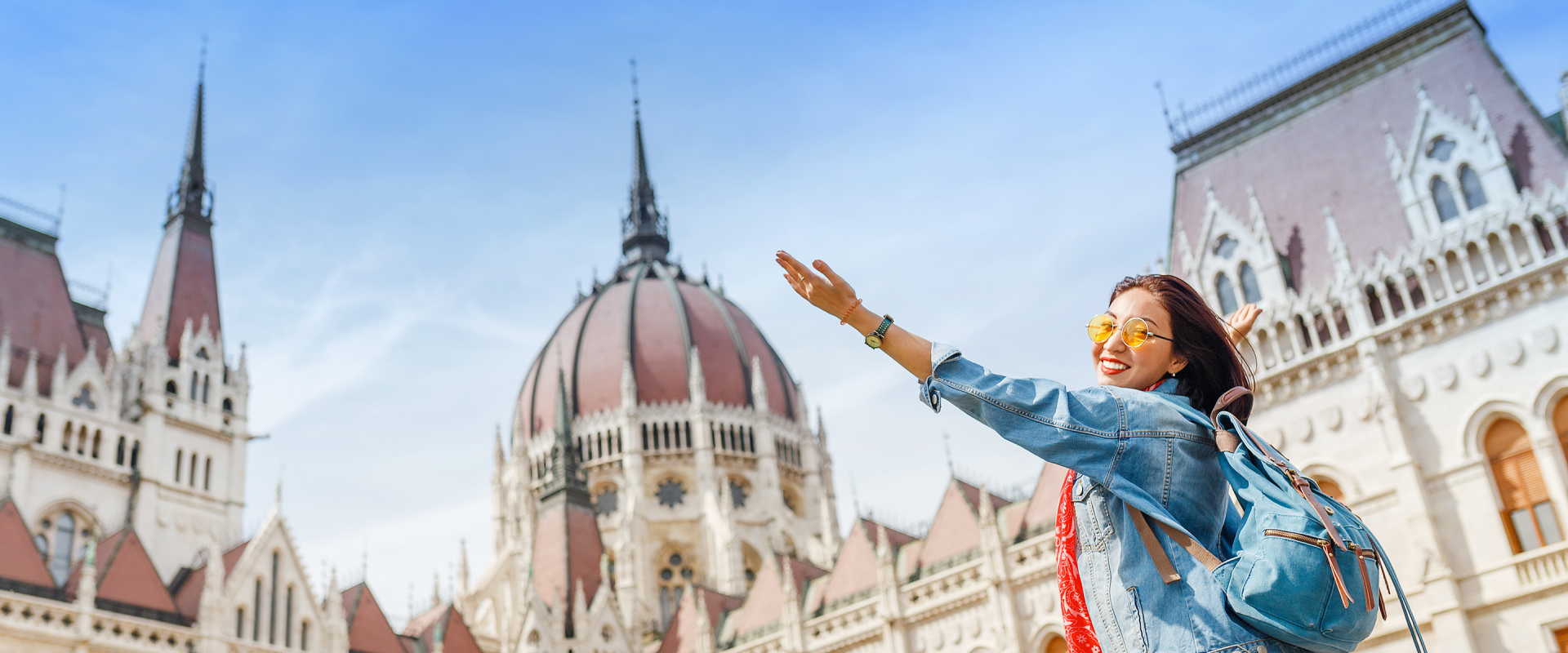 a solo female traveler on a solo travel trip to budapest, outside the hugarian palimentary building