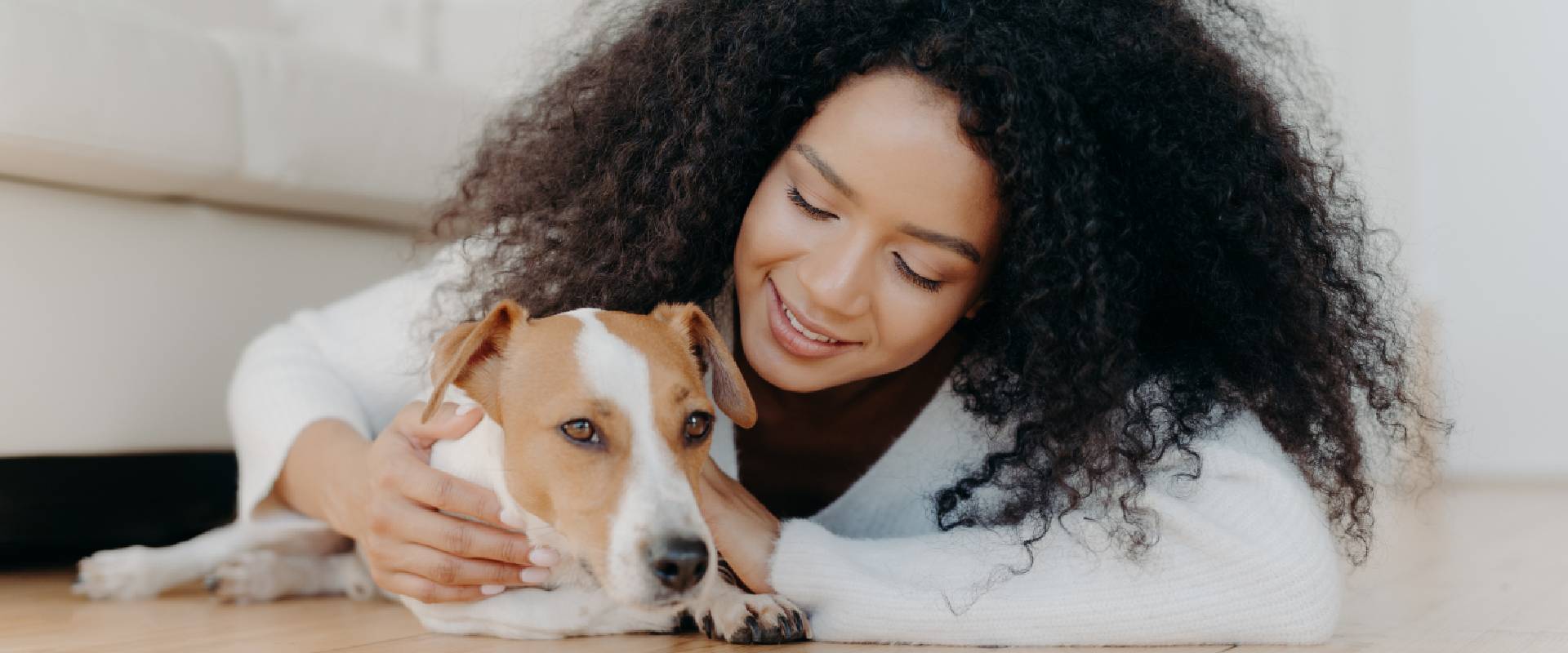 dog mom embracing a Jack Russell
