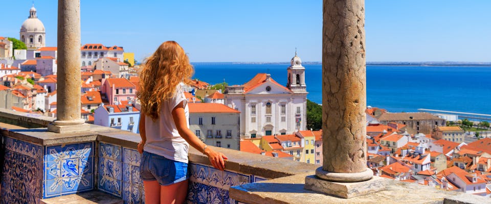 A solo female traveler enjoying views of Lisbon.
