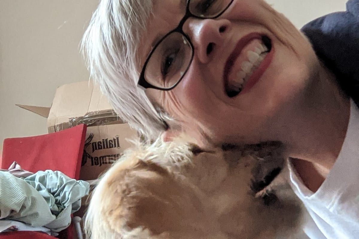 A dog licking the face of a woman