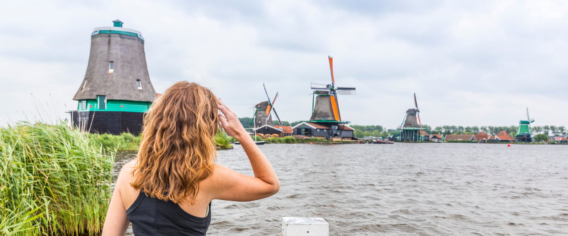 A woman looks at windmills in the Netherlands.