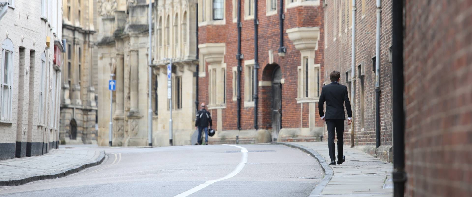 A person walking down a Cambridge street