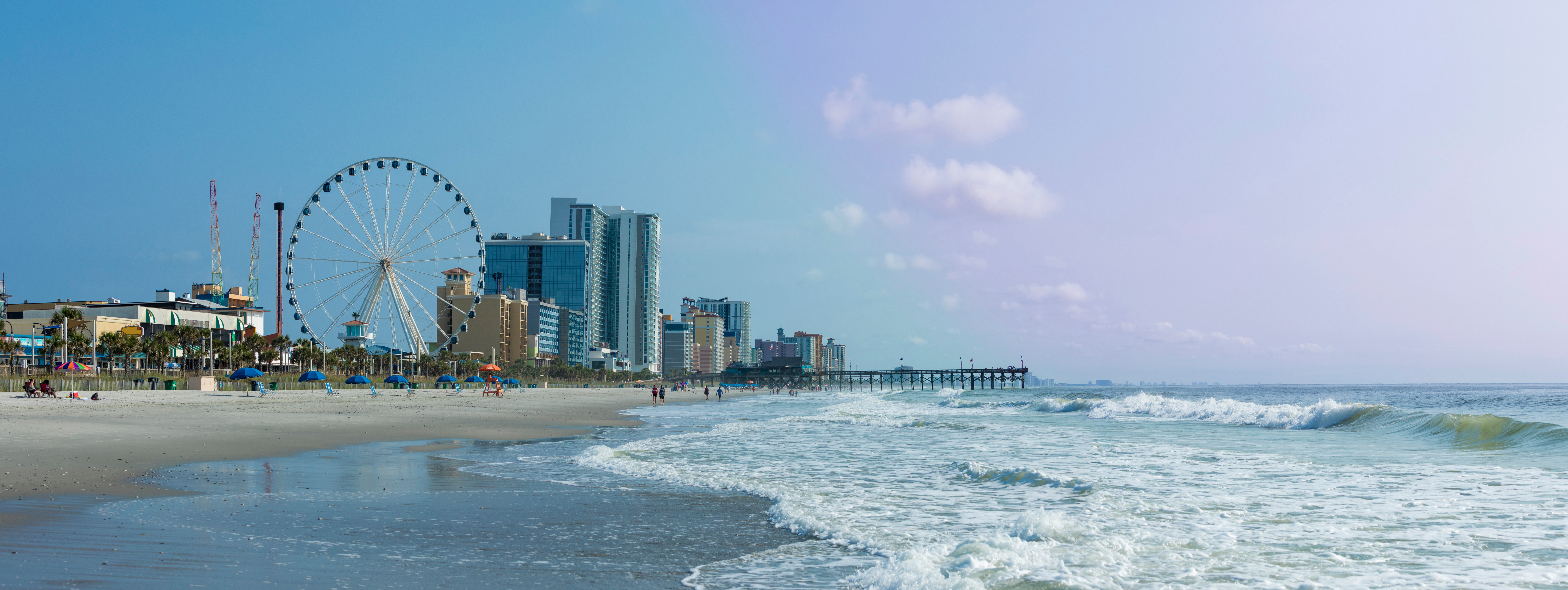 Panoramic view of Myrtle Beach, South Carolina with beach, hotels, ferris wheel, and boardwalk