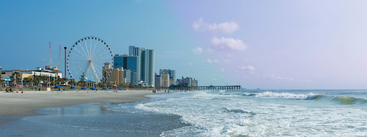 Panoramic view of Myrtle Beach, South Carolina with beach, hotels, ferris wheel, and boardwalk