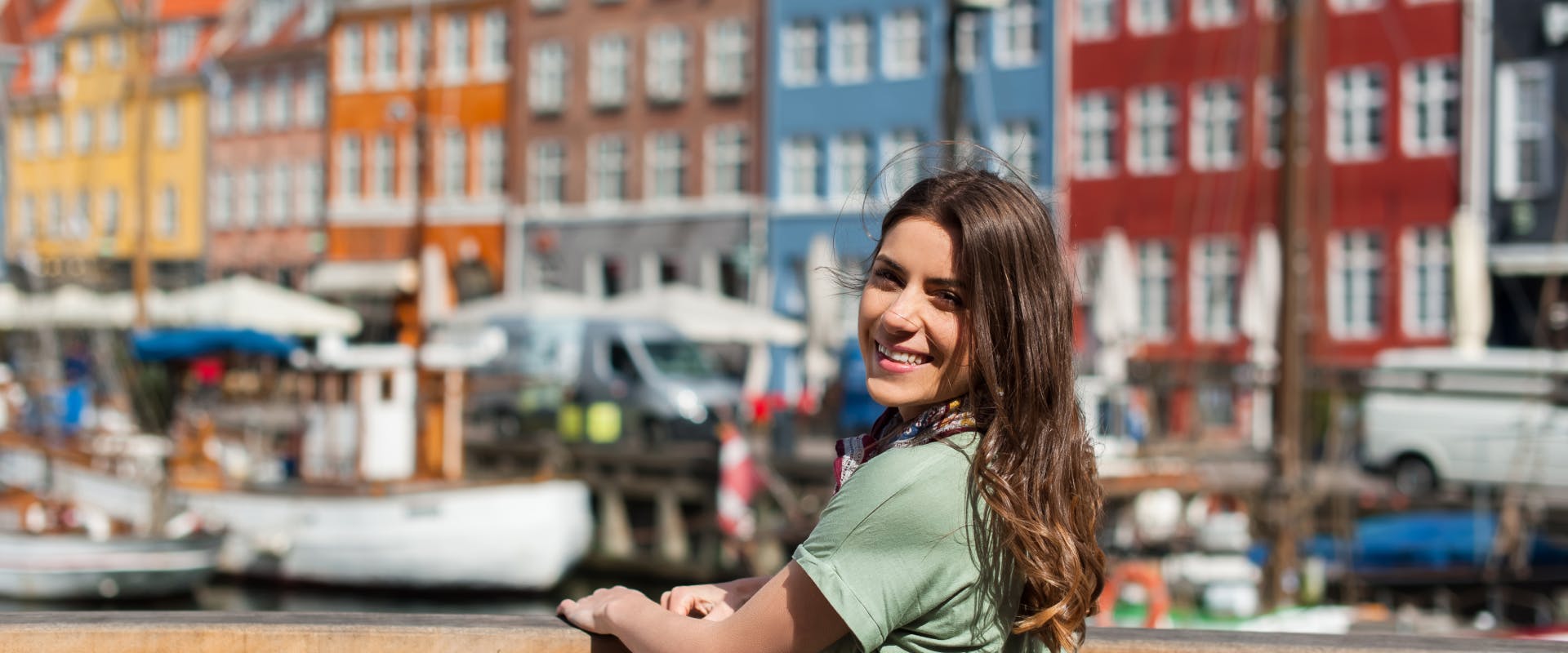 a solo female traveler enjoying a sunny day next to the Copenhagen canals