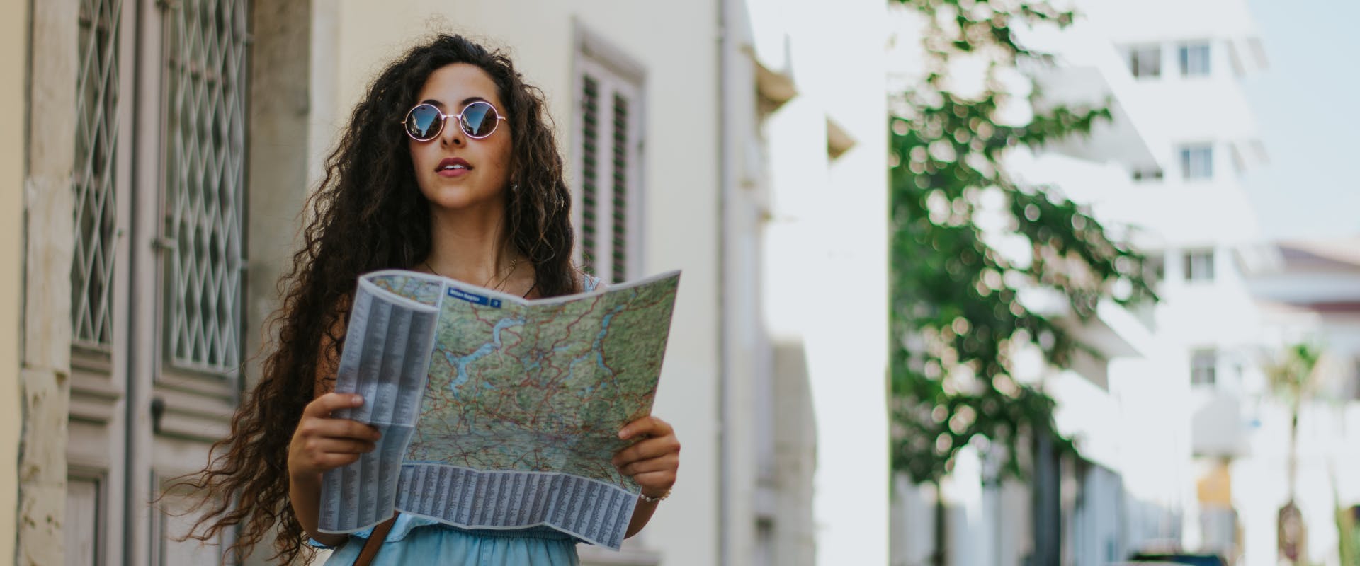 A woman reading a map on her solo trip to Spain.
