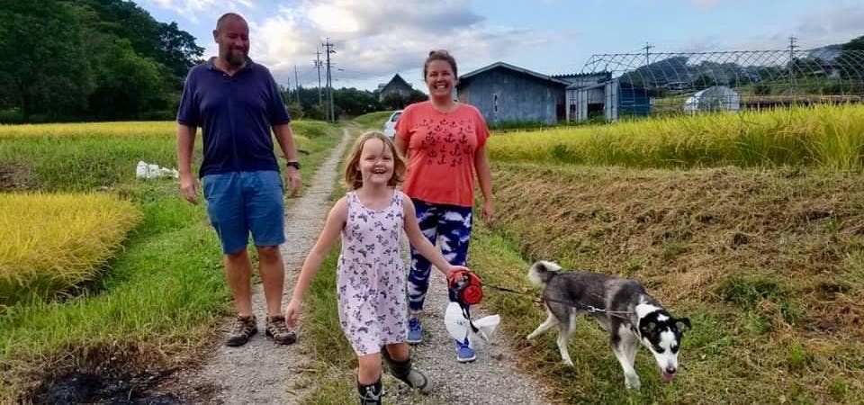 Family walking a dog