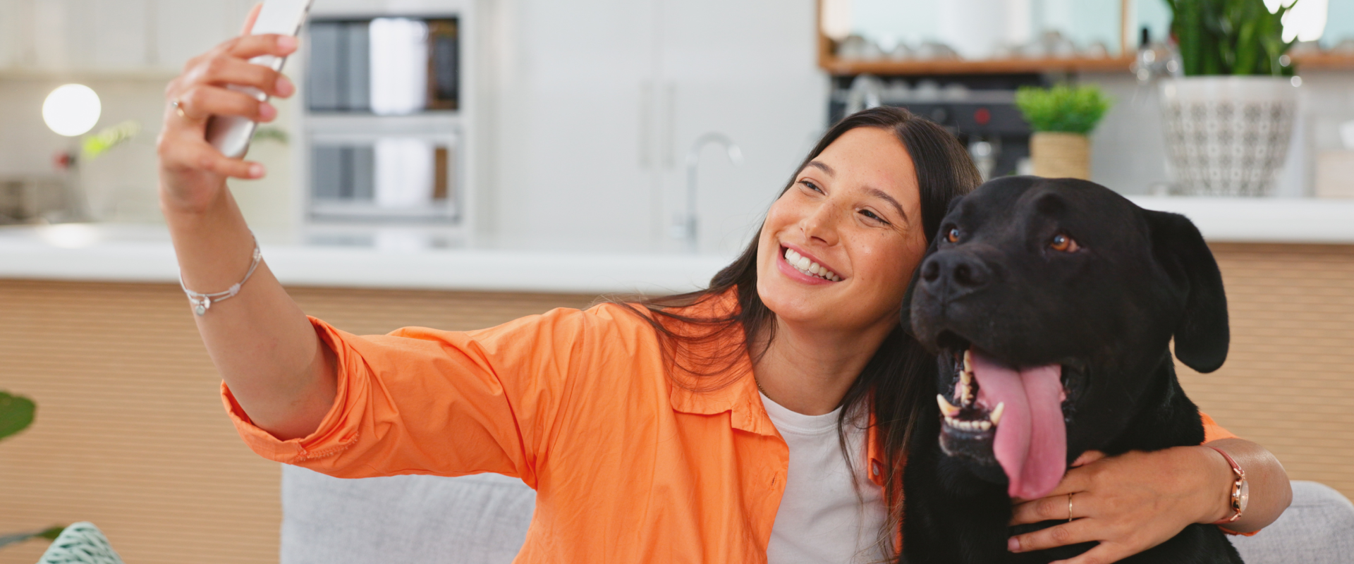A woman takes a selfie with a dog.