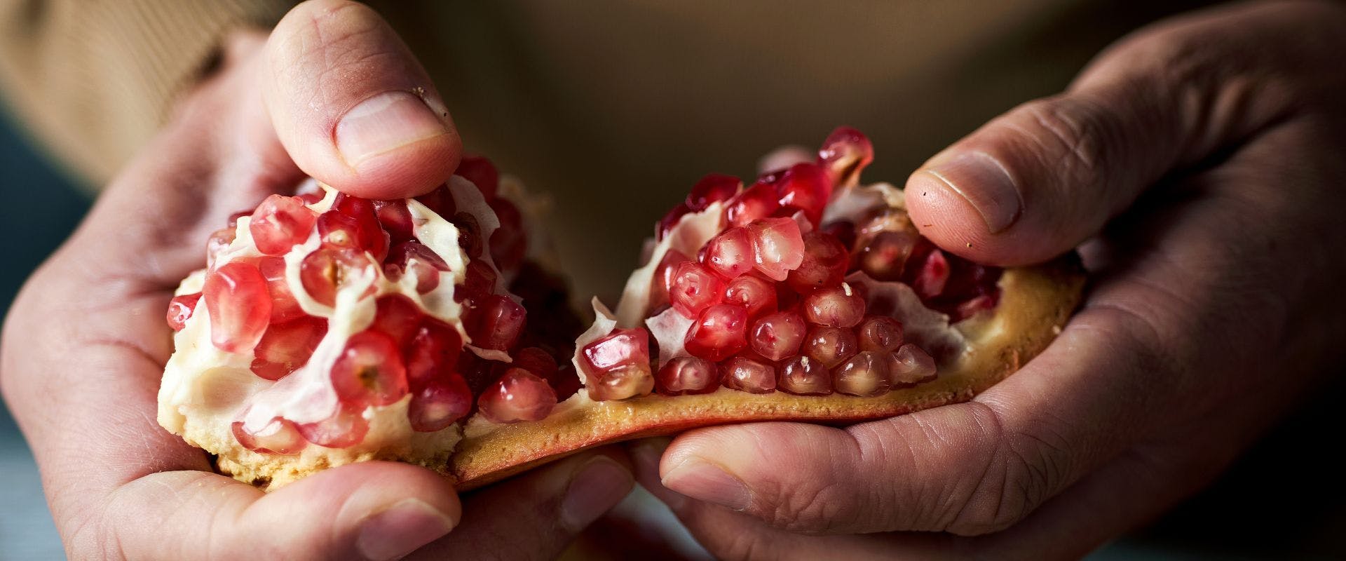 Close-up of pomegranate being broken apart