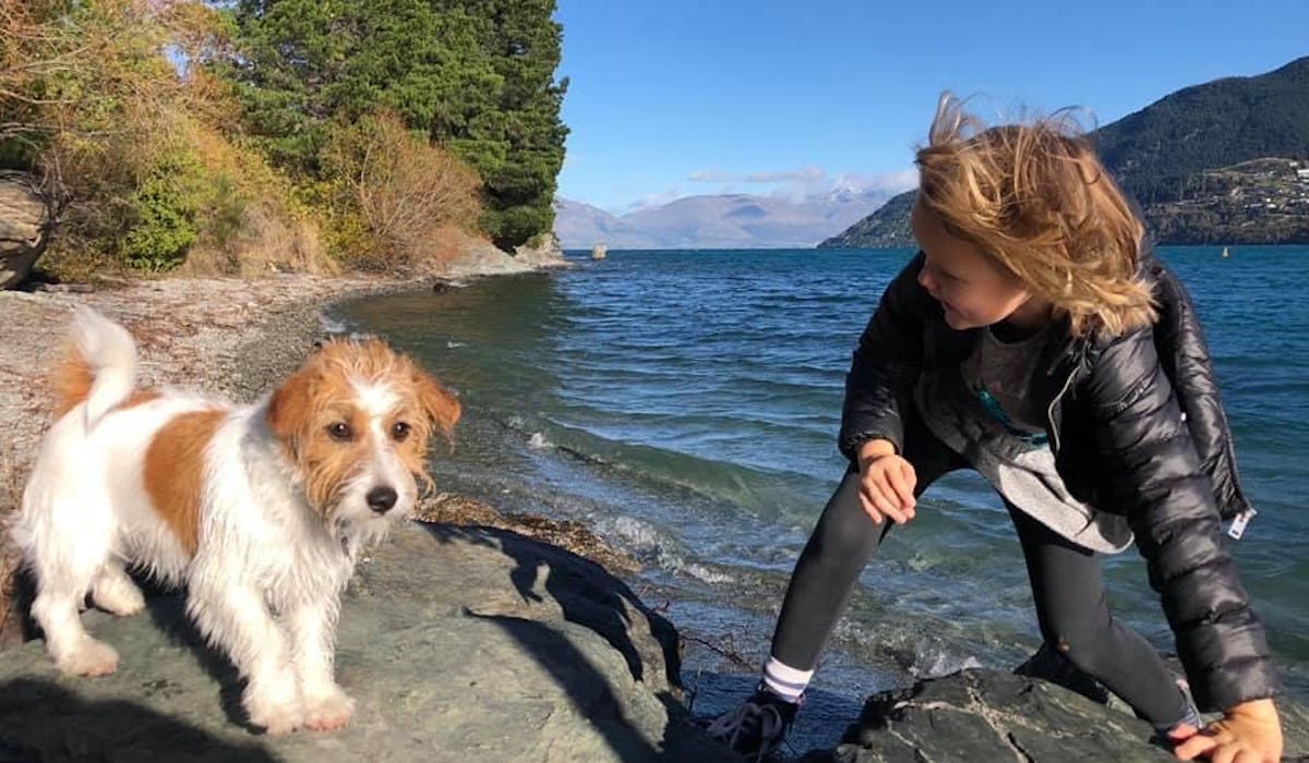 Child and dog by the mountains