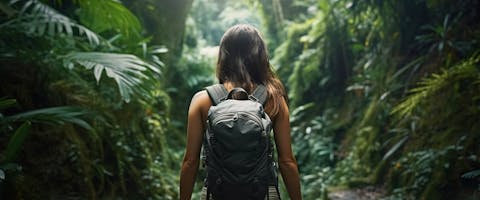 A solo female traveler walking through the jungle.