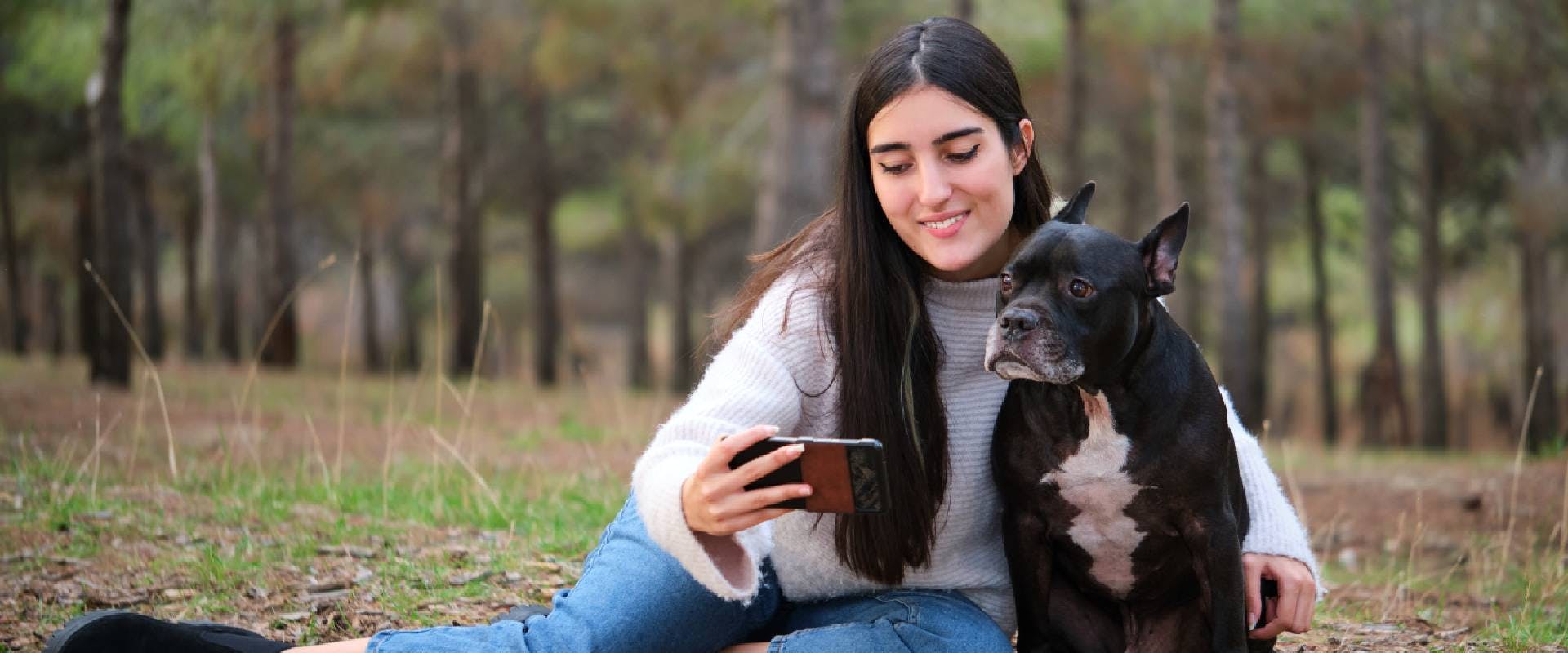 Person taking a selfie with a mixed breed dog