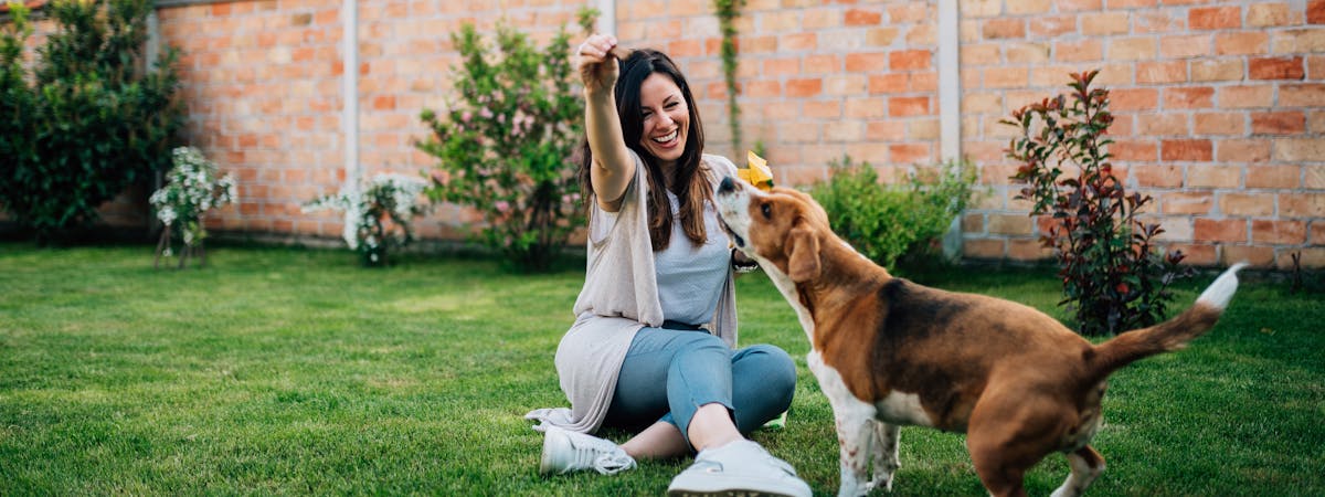 Woman holding a treat for a dog