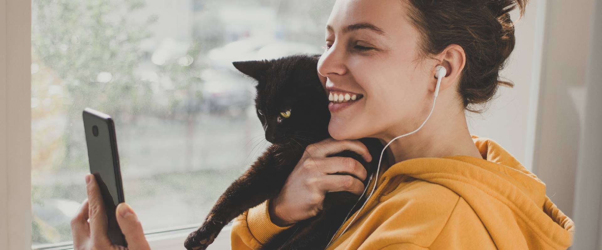 woman on a video call with a cat in her arms