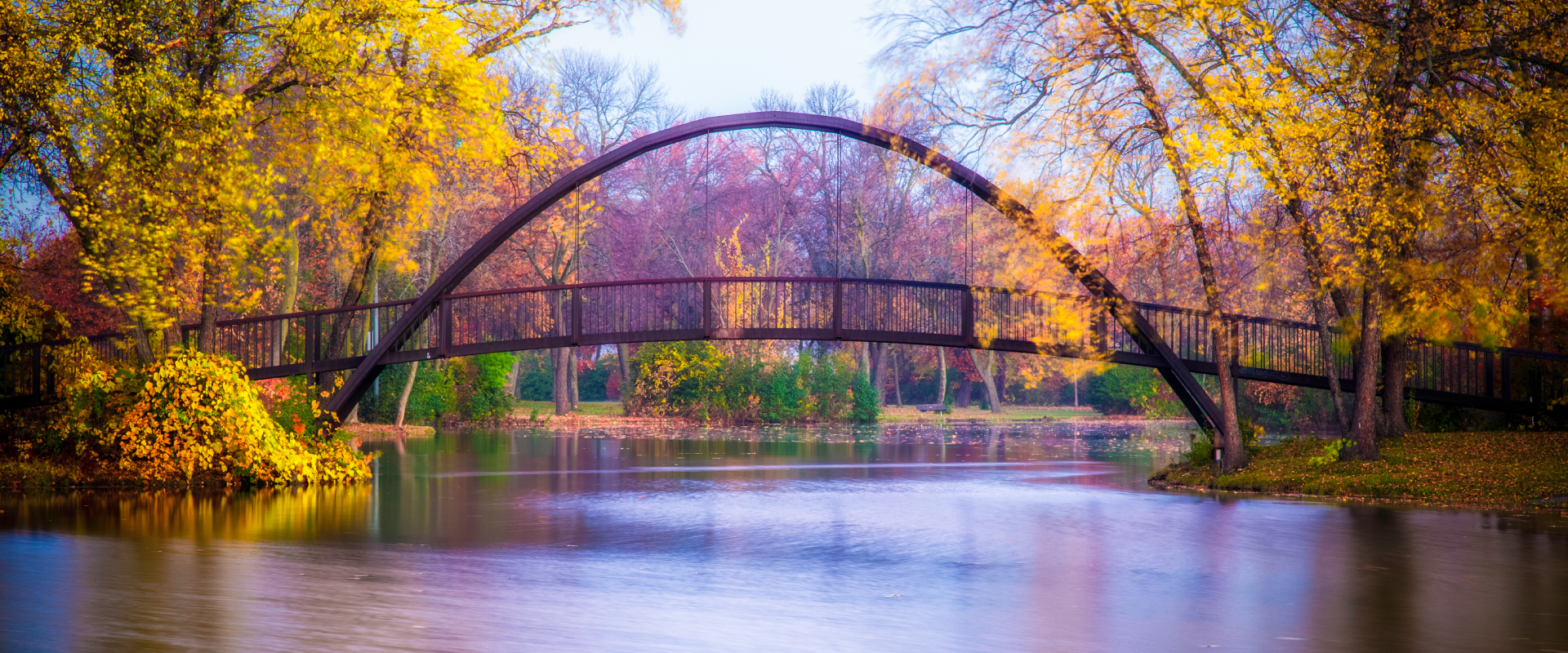 a wooden arch bridge in a park in Madison