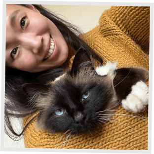 A woman hugging a cat