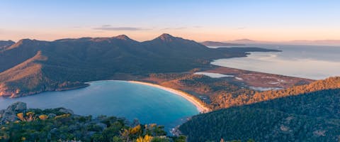 an aerial view of a bay and mountains in Tasmania