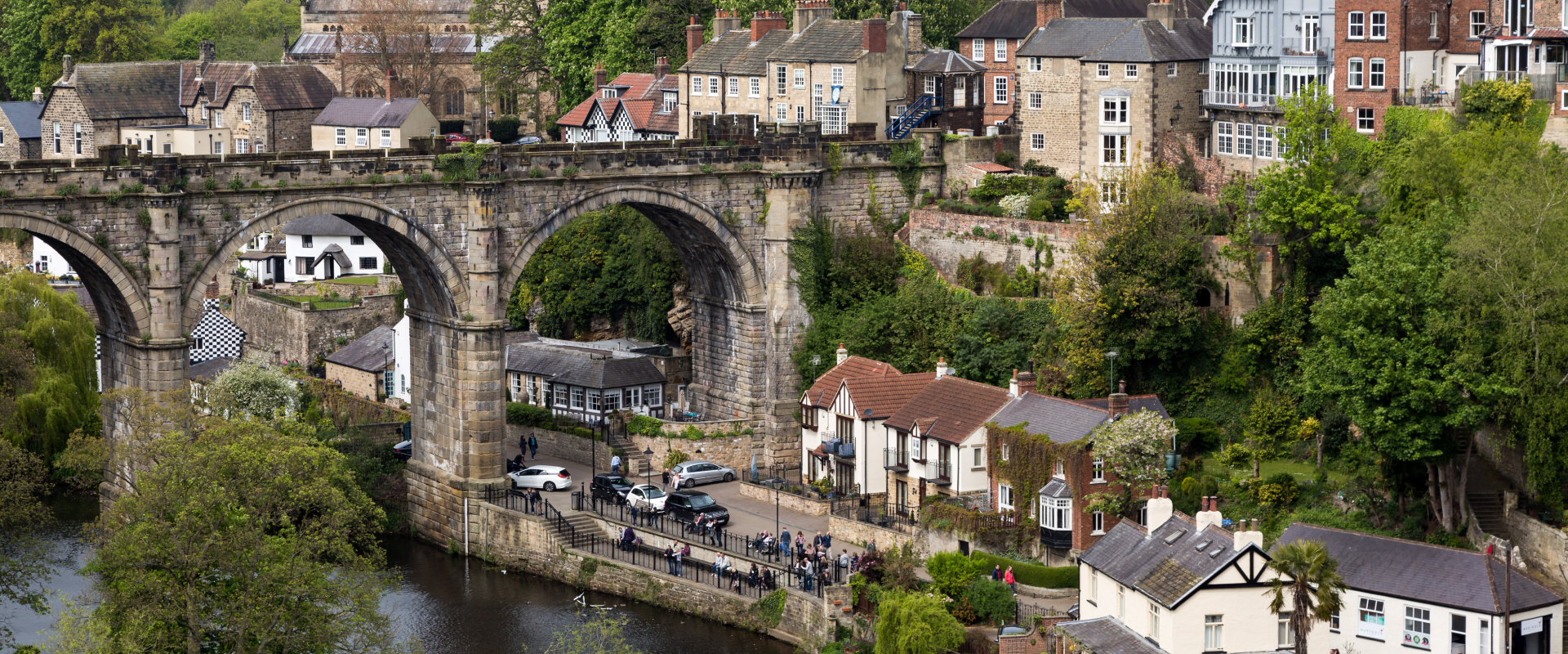 a distant riverside view of Harrogate's ancient aqua duct and surrounding houses