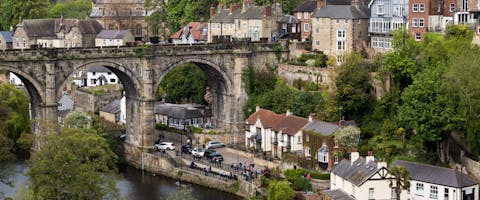 a distant riverside view of Harrogate's ancient aqua duct and surrounding houses