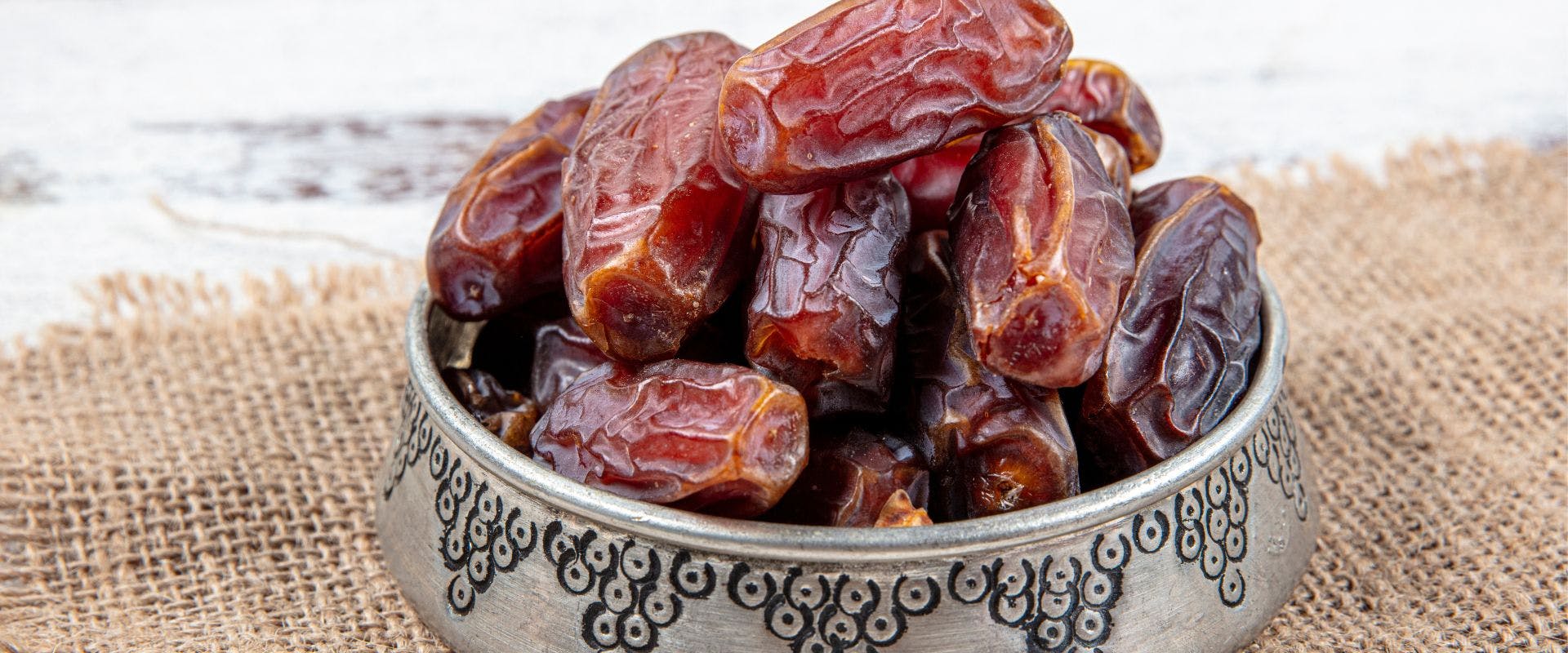 Dried dates in a metal dish