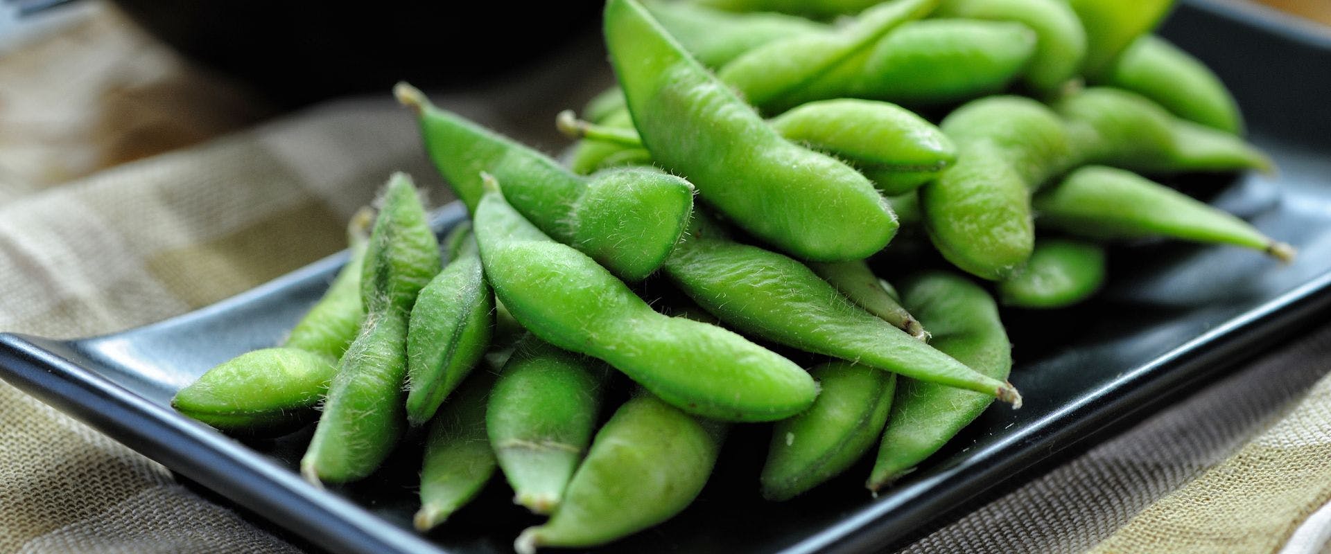 Close-up of edamame on a black plate