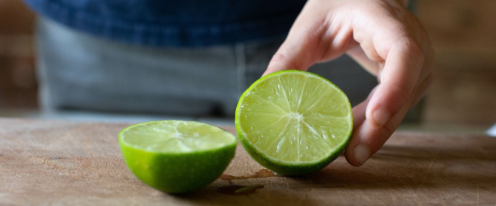 A halved lime on a chopping board