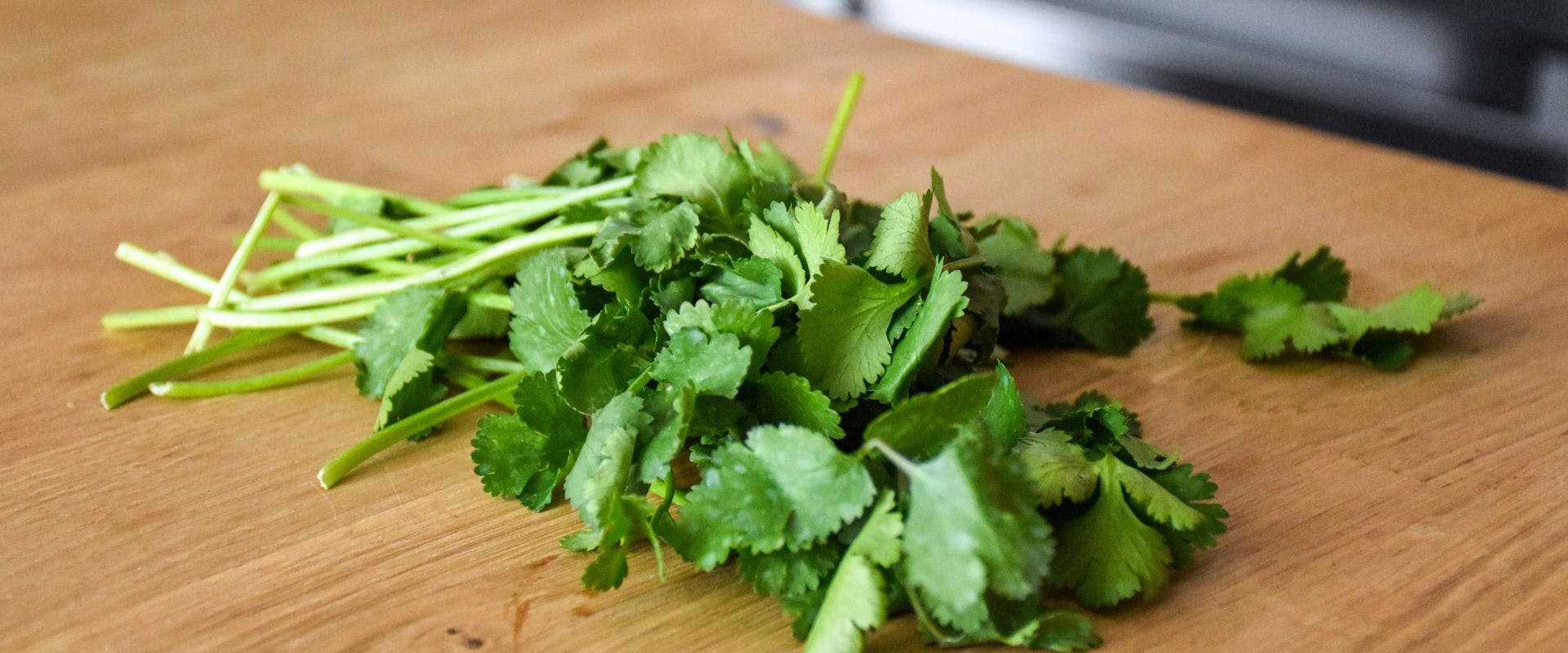 Cilantro on a wooden chopping board