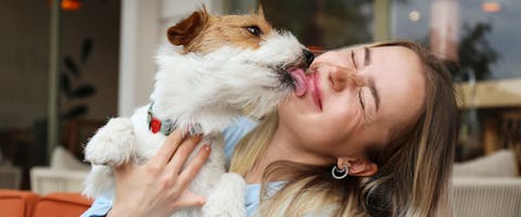 A dog licking a woman.
