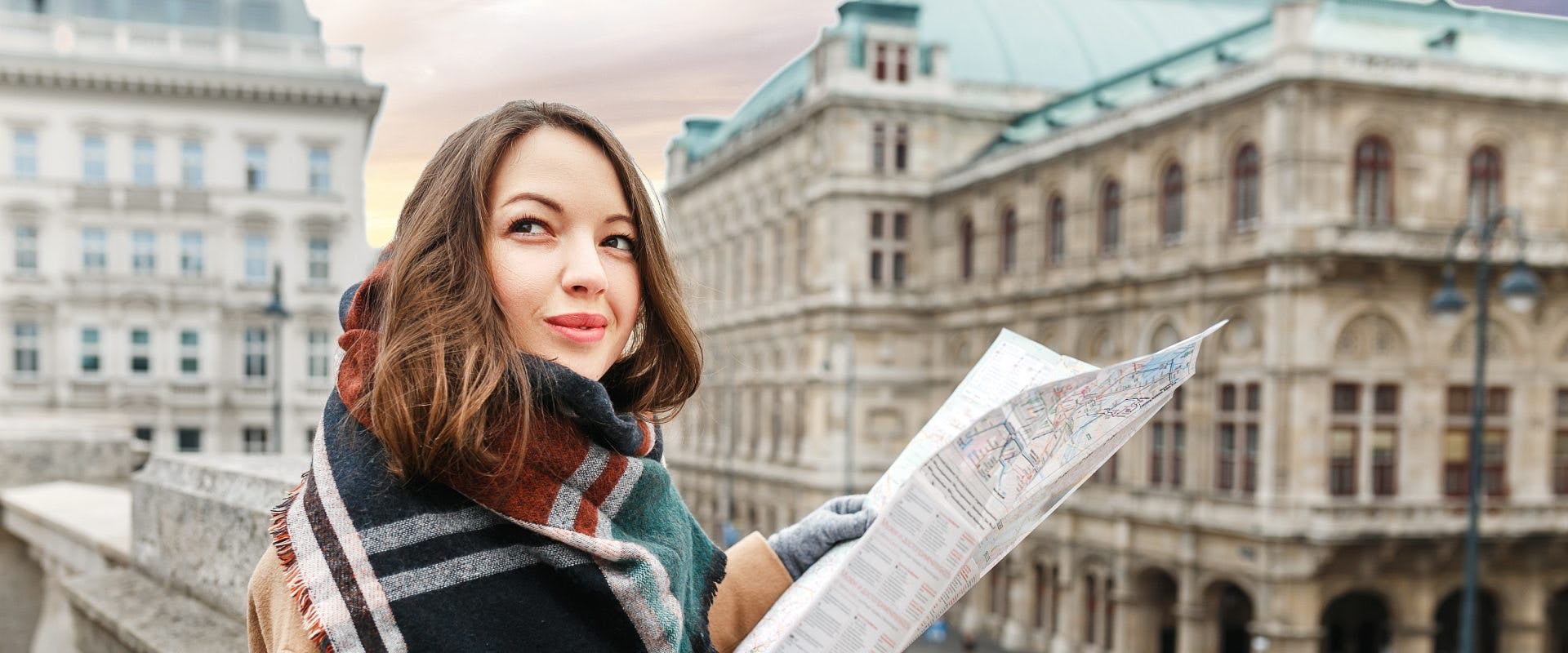 A solo female traveler in Vienna looking at a map.