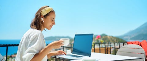 Person working remotely by the sea