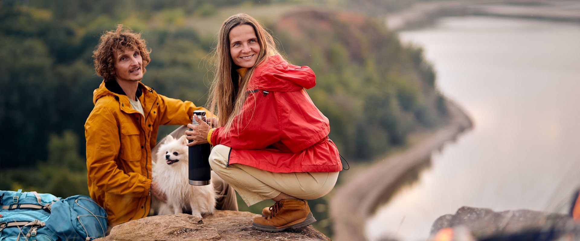 Couple with pet dog enjoying hiking trip