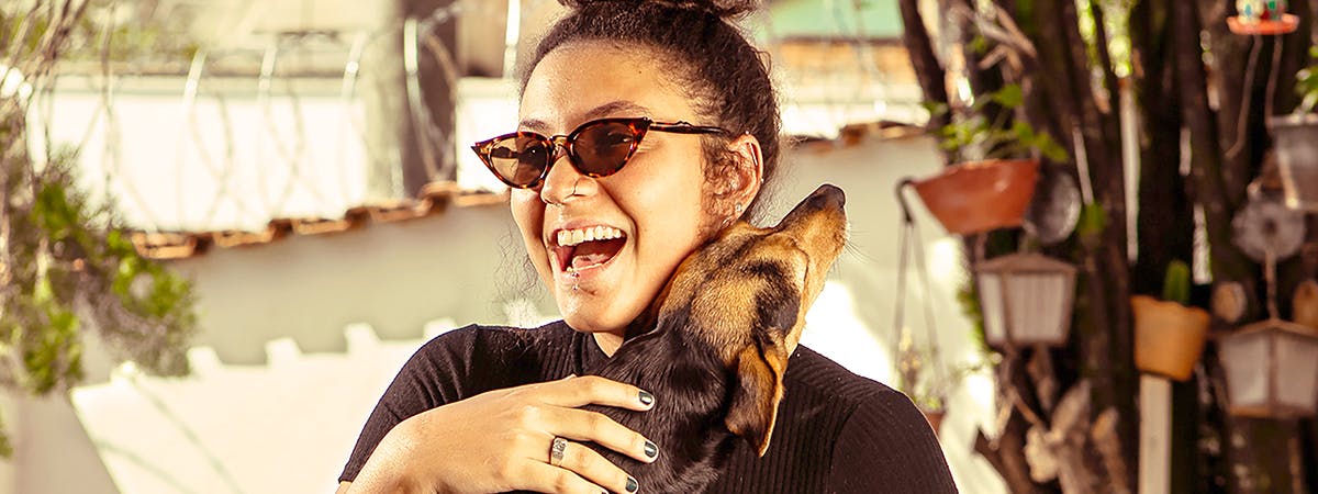 Woman cuddling a dog