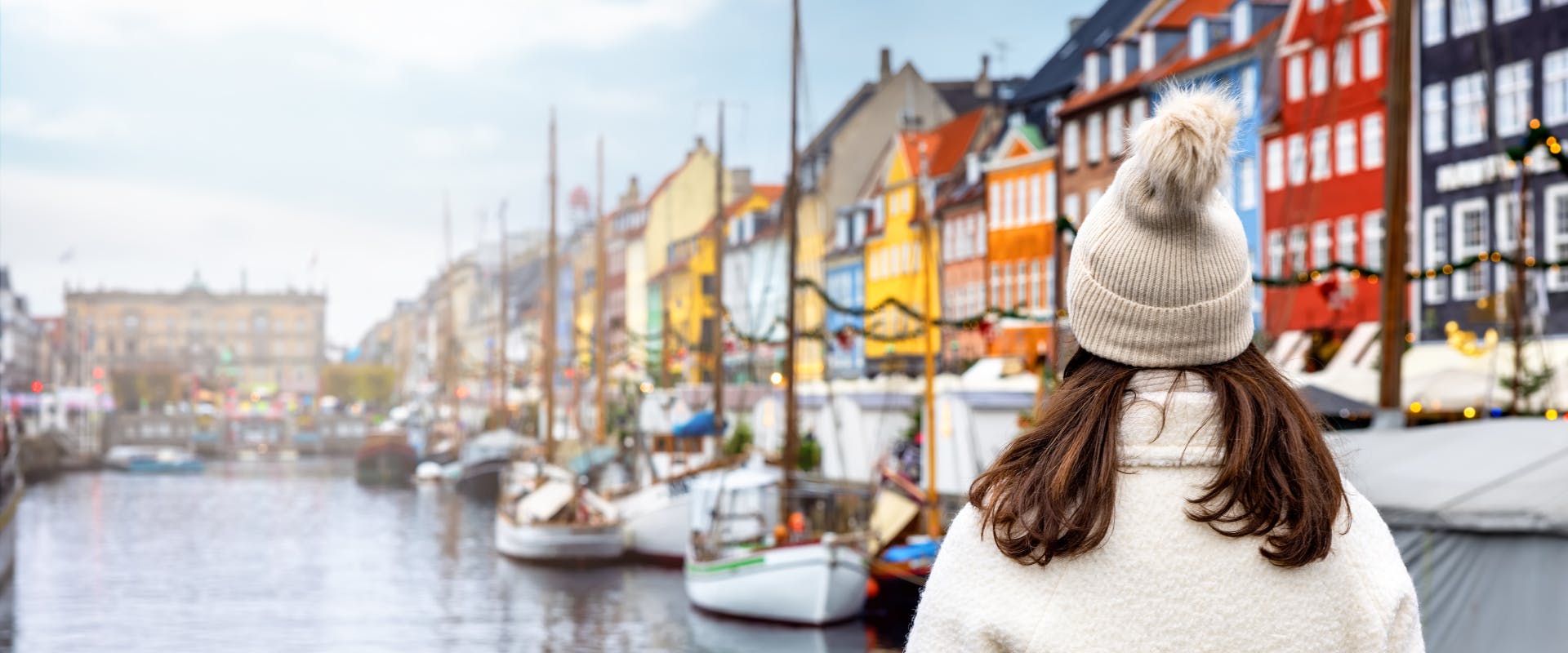 a solo female traveler in Copenhagen looking at the city's canals
