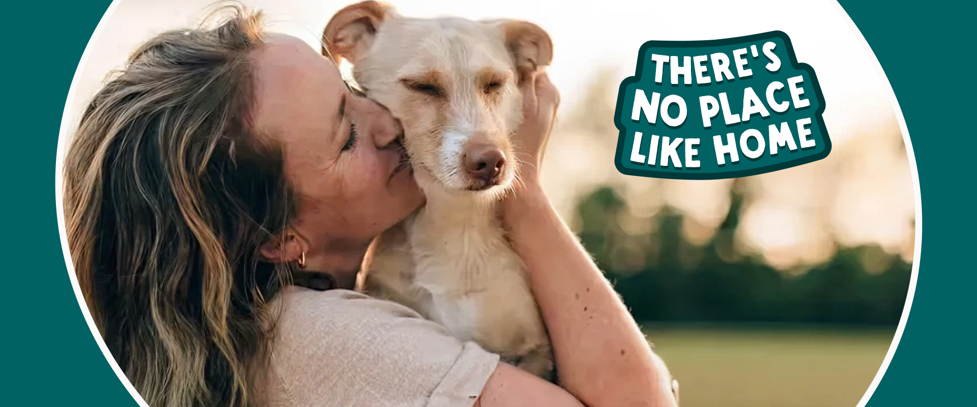 Person embracing a dog outdoors