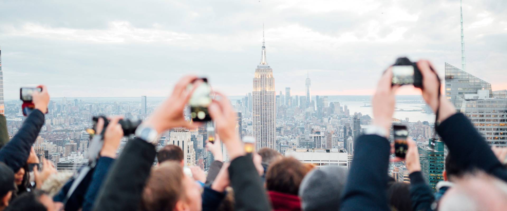 Tourists on a rooftop in New York City taking pictures