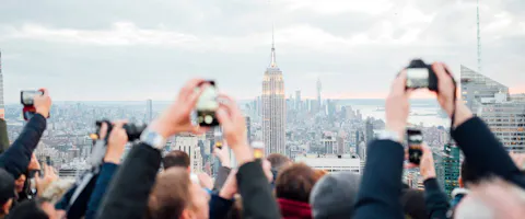 Tourists on a rooftop in New York City taking pictures