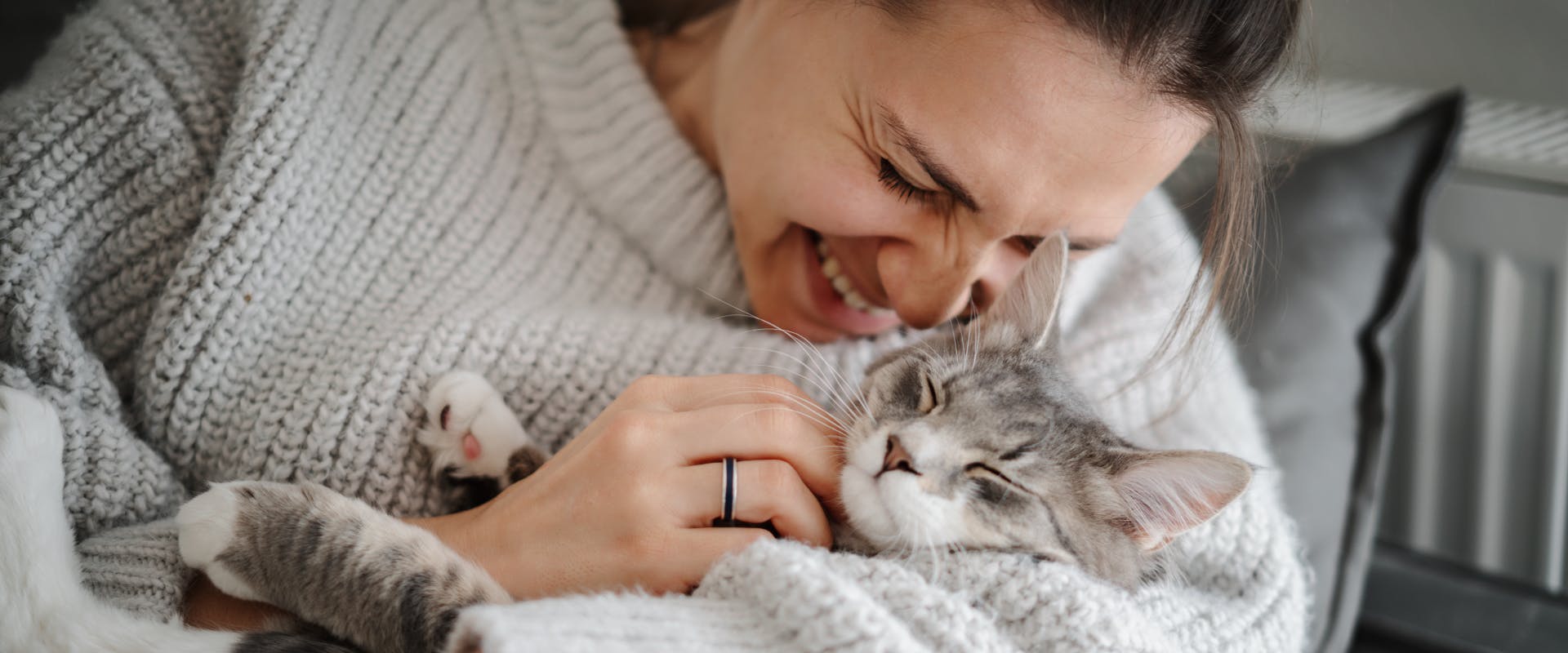 A woman cuddling a cat.
