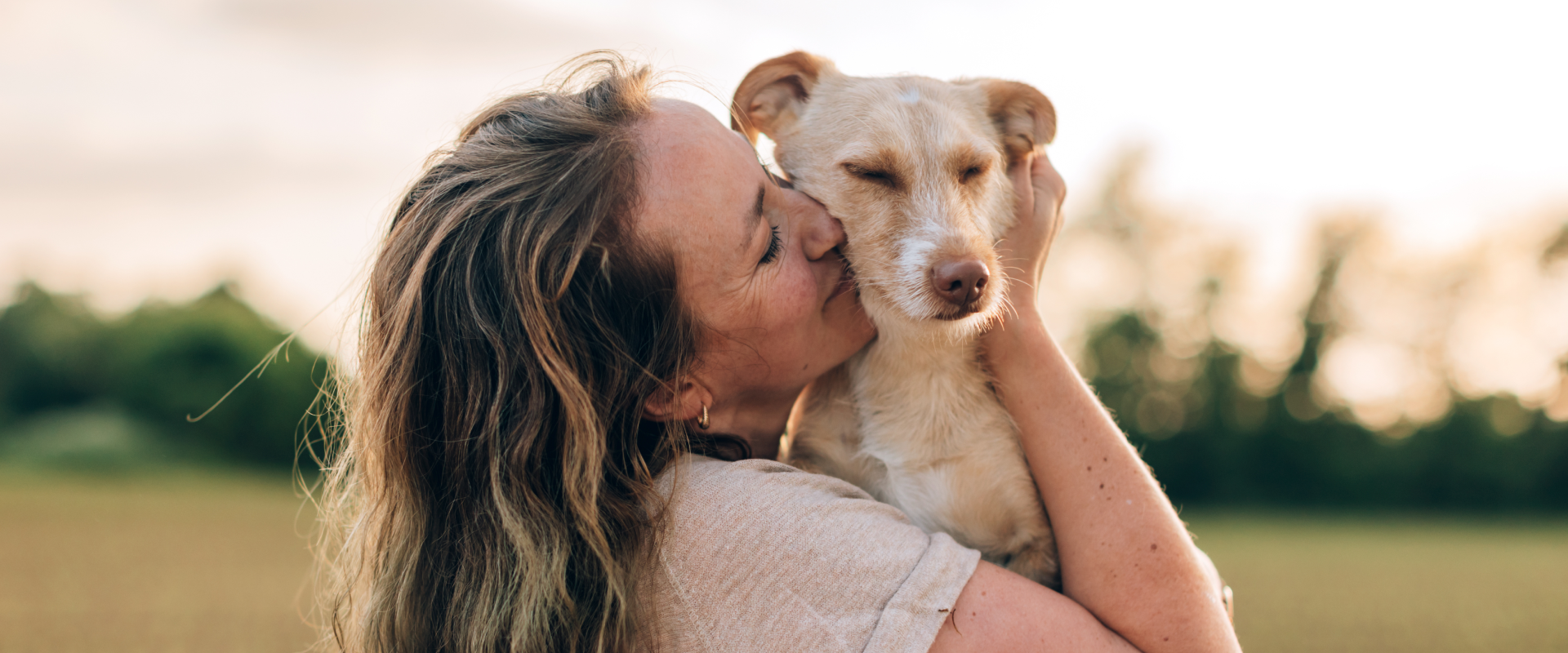 A woman hugging a dog. 