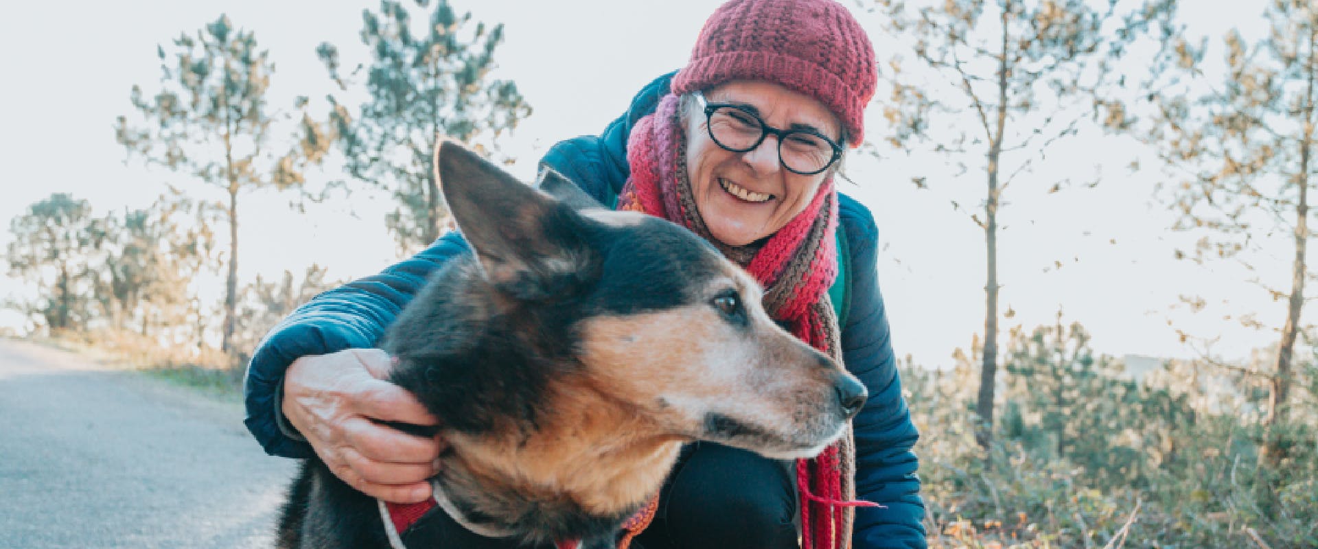 A dog owner embraces her dog.